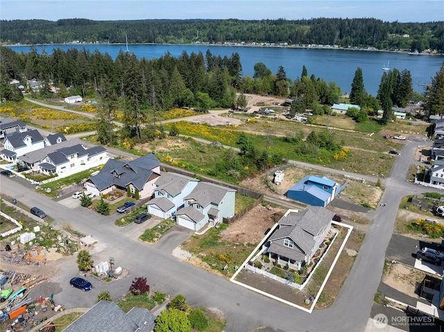 210 E Cedarland Ln, Allyn, WA 98524 - aerial view of property's location with a forest, property parcel outlined, a large body of water, and nearby suburban area