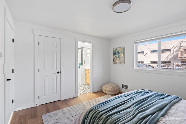 3009 Heath Ct, Steilacoom, WA 98388 - bedroom with light wood finished floors, ensuite bath, and baseboards