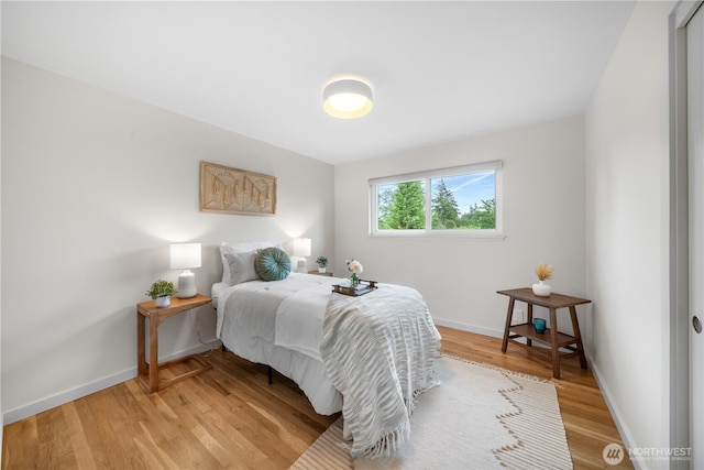 bedroom with light wood-style floors and baseboards