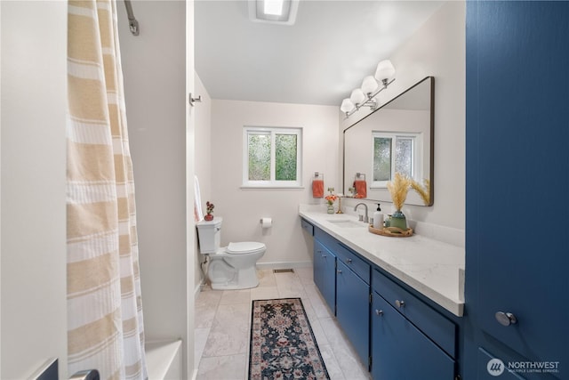 bathroom featuring toilet, vanity, a shower with curtain, and baseboards