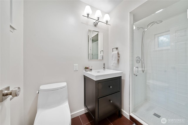 full bath featuring a stall shower, toilet, vanity, and tile patterned flooring