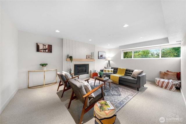 carpeted living area featuring a fireplace, recessed lighting, and baseboards
