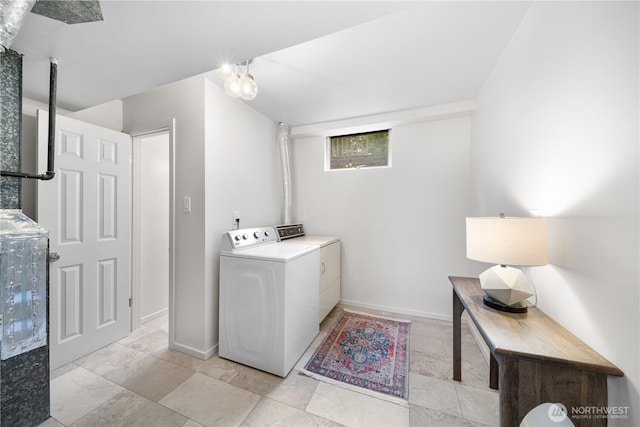 laundry area featuring washing machine and dryer and baseboards