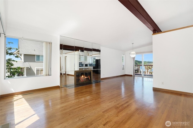 1006 N 36th St, Renton, WA 98056 - unfurnished living room featuring wood finished floors, baseboards, and a fireplace with flush hearth