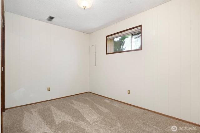 1006 N 36th St, Renton, WA 98056 - unfurnished room featuring carpet, a textured ceiling, and baseboards