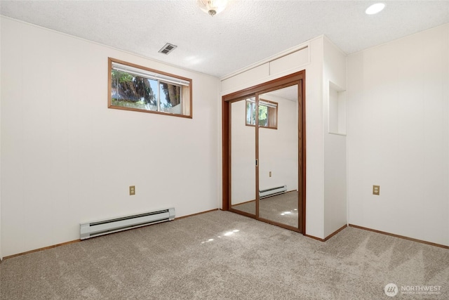1006 N 36th St, Renton, WA 98056 - unfurnished bedroom featuring a baseboard radiator, carpet, a textured ceiling, and a closet