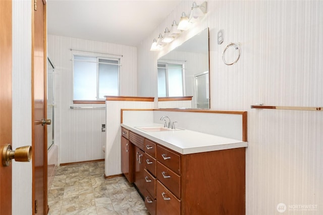 1006 N 36th St, Renton, WA 98056 - full bathroom with wallpapered walls, vanity, toilet, baseboards, and bath / shower combo with glass door