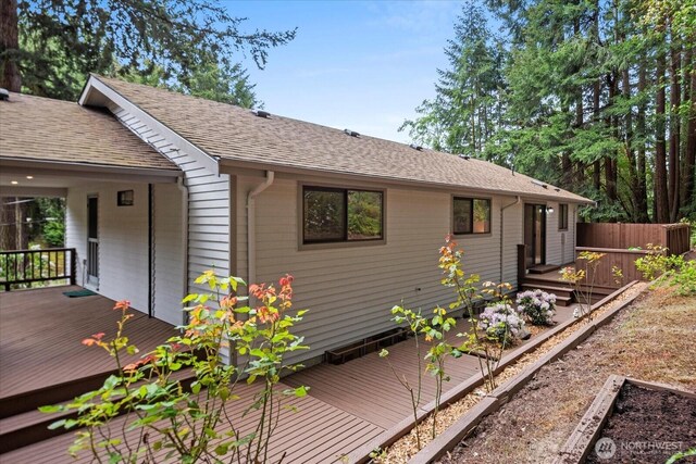 7517 Olympic View Dr, Edmonds, WA 98026 - view of side of home featuring a wooden deck, a shingled roof, and fence