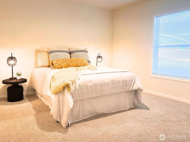 bedroom with carpet flooring and baseboards