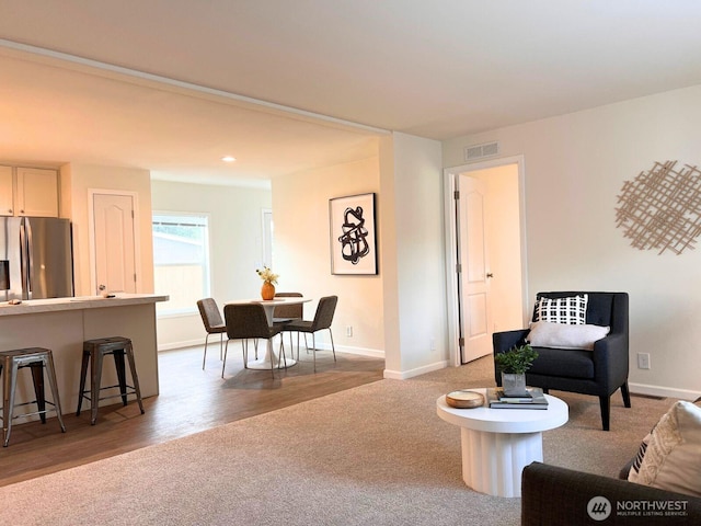 living room with baseboards, carpet, wood finished floors, and recessed lighting