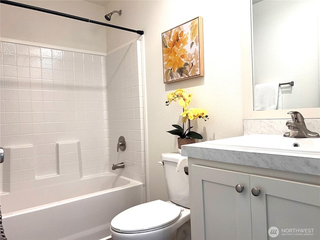 bathroom with toilet, vanity, and washtub / shower combination