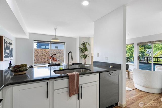9222 Roosevelt Way NE Unit 302, Seattle, WA 98115 - kitchen featuring dishwasher, dark countertops, white cabinetry, light wood-style floors, and recessed lighting