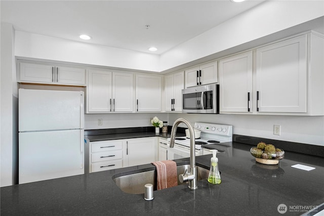 9222 Roosevelt Way NE Unit 302, Seattle, WA 98115 - kitchen featuring white appliances, recessed lighting, dark stone counters, and white cabinetry