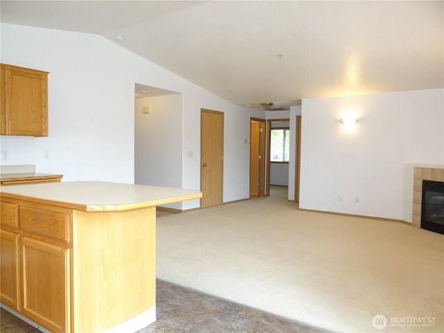 1954 Meadowood Loop, Woodland, WA 98674 - kitchen with open floor plan, light countertops, lofted ceiling, light carpet, and a fireplace