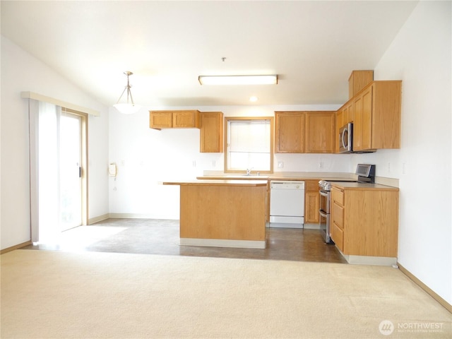 1954 Meadowood Loop, Woodland, WA 98674 - kitchen featuring stainless steel appliances, a kitchen island, light countertops, baseboards, and light carpet