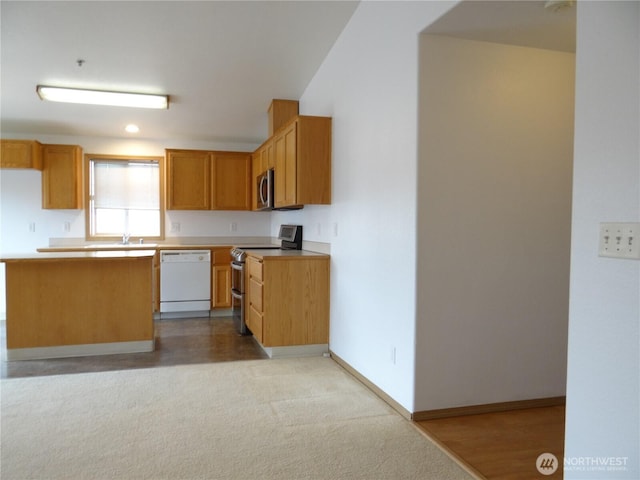 1954 Meadowood Loop, Woodland, WA 98674 - kitchen with stainless steel appliances, a sink, light countertops, baseboards, and recessed lighting