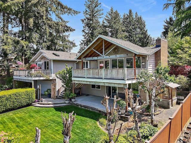 back of property with stairway, a patio area, a wooden deck, a lawn, and a chimney