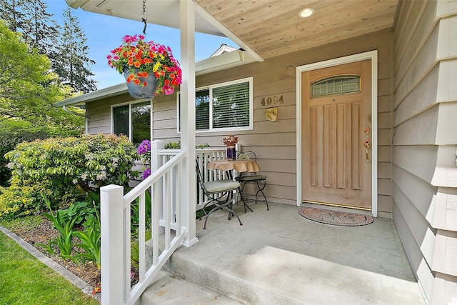 view of exterior entry with a porch