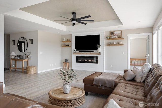 247 Devereese Rd, Chehalis, WA 98532 - living room with a raised ceiling, ceiling fan, baseboards, wood finished floors, and a large fireplace