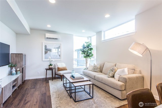 living room with a wall mounted AC, dark wood-type flooring, recessed lighting, and baseboards