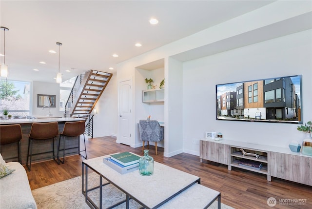 living room featuring dark wood-style floors, stairway, recessed lighting, and baseboards