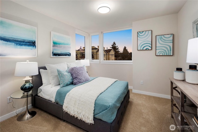 carpeted bedroom featuring baseboards
