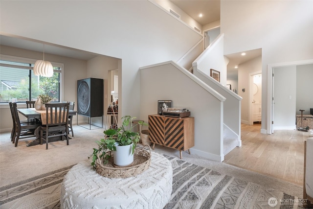 1075 SW 12th St, North Bend, WA 98045 - living room with stairway, a towering ceiling, light colored carpet, and recessed lighting