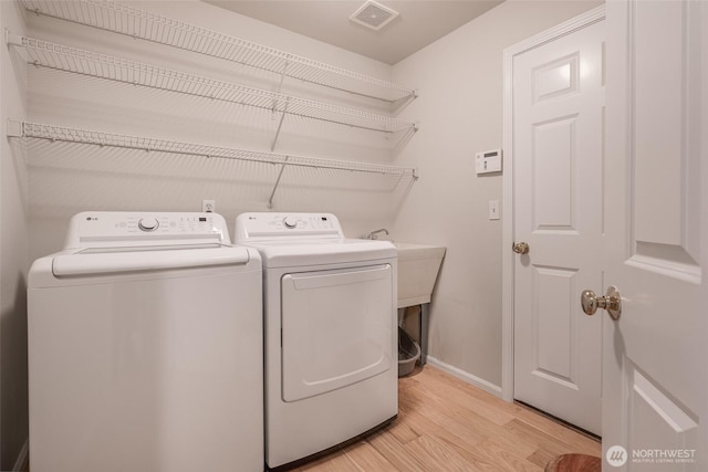 1075 SW 12th St, North Bend, WA 98045 - laundry room featuring washing machine and dryer and light wood finished floors