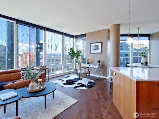 10700 NE 4th St Unit 2710, Bellevue, WA 98004 - living room with dark wood finished floors, baseboards, a chandelier, healthy amount of natural light, and floor to ceiling windows