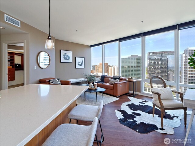 10700 NE 4th St Unit 2710, Bellevue, WA 98004 - living area with dark wood finished floors, floor to ceiling windows, and a city view