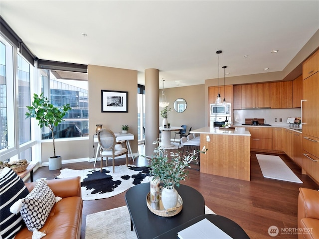 10700 NE 4th St Unit 2710, Bellevue, WA 98004 - living area with dark wood-type flooring, baseboards, and recessed lighting