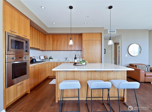 10700 NE 4th St Unit 2710, Bellevue, WA 98004 - kitchen with stainless steel appliances, modern cabinets, a kitchen breakfast bar, and dark wood finished floors
