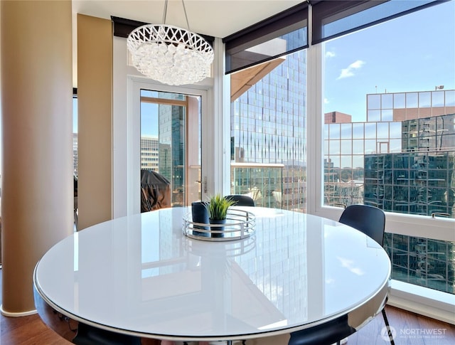 10700 NE 4th St Unit 2710, Bellevue, WA 98004 - dining area featuring wood finished floors, healthy amount of natural light, a chandelier, and a city view