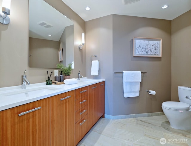 10700 NE 4th St Unit 2710, Bellevue, WA 98004 - full bathroom featuring toilet, double vanity, recessed lighting, and baseboards