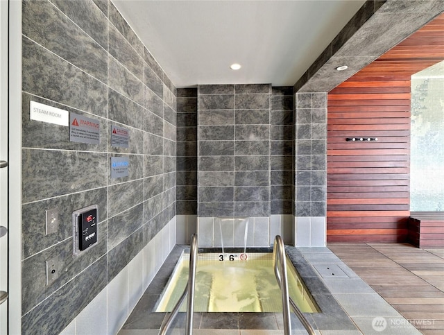 10700 NE 4th St Unit 2710, Bellevue, WA 98004 - bathroom featuring tile walls, recessed lighting, and elevator