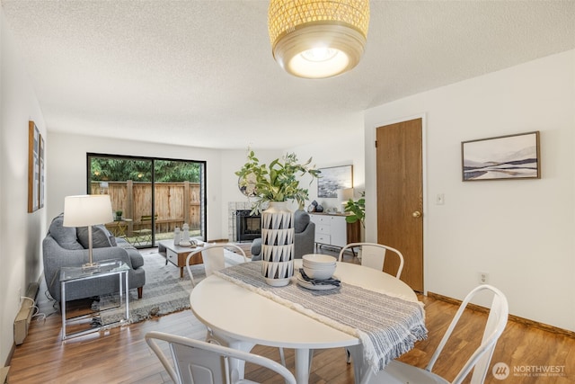 1820 SW 318th Pl Unit 26D, Federal Way, WA 98023 - dining room with wood finished floors and a textured ceiling