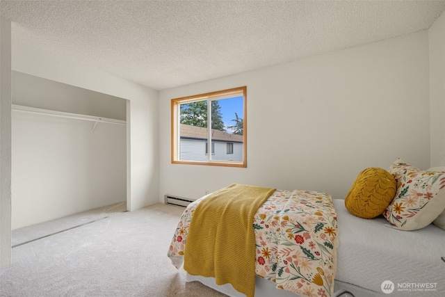 1820 SW 318th Pl Unit 26D, Federal Way, WA 98023 - bedroom with a baseboard radiator, carpet, a closet, and a textured ceiling