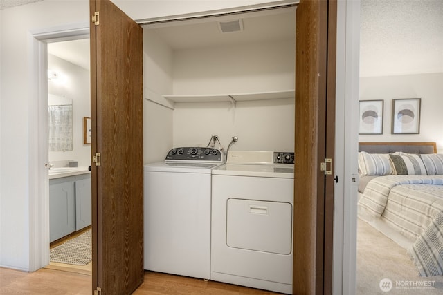 1820 SW 318th Pl Unit 26D, Federal Way, WA 98023 - washroom featuring separate washer and dryer and light wood-style floors
