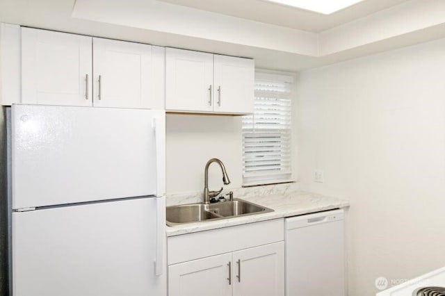 kitchen featuring white appliances, a sink, white cabinetry, and light countertops