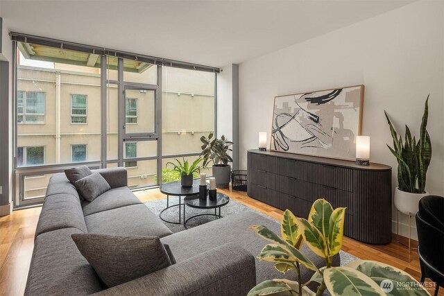 2911 2nd Ave Unit 411, Seattle, WA 98121 - living area with wood finished floors and expansive windows