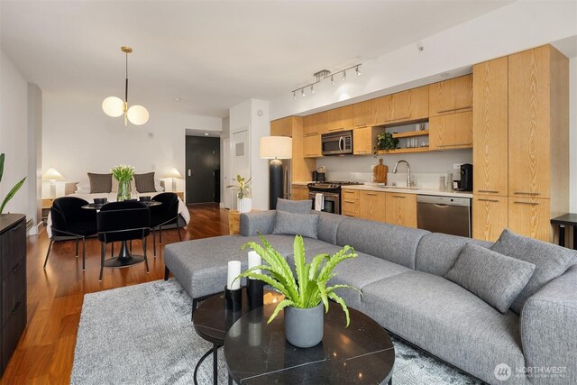 2911 2nd Ave Unit 411, Seattle, WA 98121 - living room with wood finished floors and track lighting