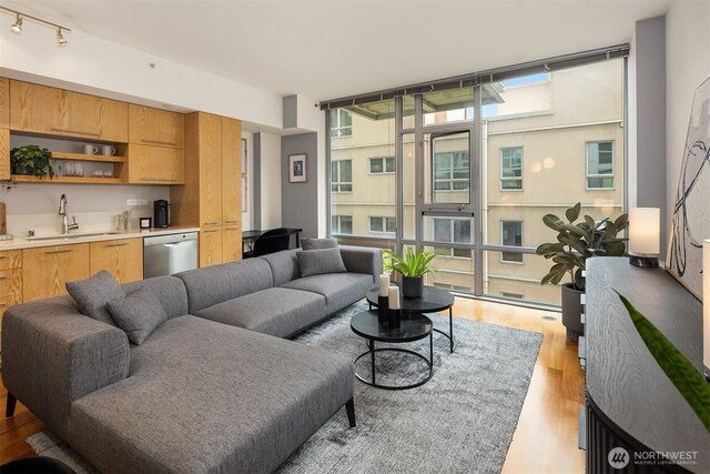 2911 2nd Ave Unit 411, Seattle, WA 98121 - living area featuring a wall of windows, light wood-style floors, and track lighting