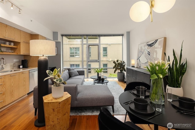 2911 2nd Ave Unit 411, Seattle, WA 98121 - living room with floor to ceiling windows, light wood finished floors, and track lighting