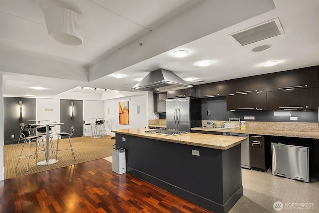 2911 2nd Ave Unit 411, Seattle, WA 98121 - kitchen featuring appliances with stainless steel finishes, modern cabinets, island exhaust hood, a center island, and light wood-type flooring