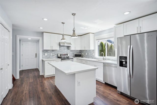 9348 54th Ave S, Seattle, WA 98118 - kitchen with stainless steel appliances, a sink, tasteful backsplash, white cabinets, and recessed lighting