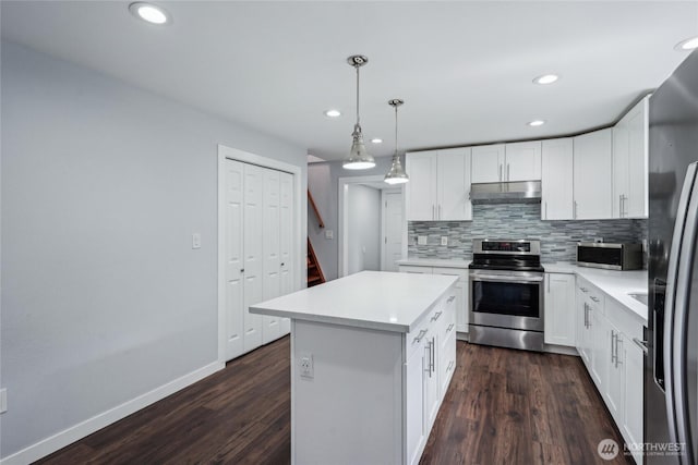 9348 54th Ave S, Seattle, WA 98118 - kitchen with appliances with stainless steel finishes, under cabinet range hood, backsplash, light countertops, and recessed lighting