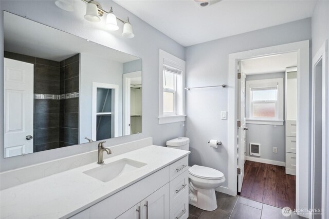 9348 54th Ave S, Seattle, WA 98118 - bathroom with plenty of natural light, toilet, vanity, and baseboards