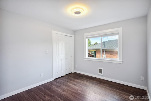 9348 54th Ave S, Seattle, WA 98118 - unfurnished bedroom with baseboards, dark wood-style floors, and a closet