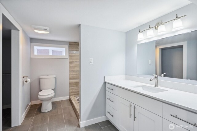 9348 54th Ave S, Seattle, WA 98118 - full bath featuring toilet, a shower stall, vanity, baseboards, and tile patterned floors