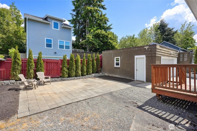 9348 54th Ave S, Seattle, WA 98118 - view of patio featuring a fenced backyard, an outbuilding, and a wooden deck